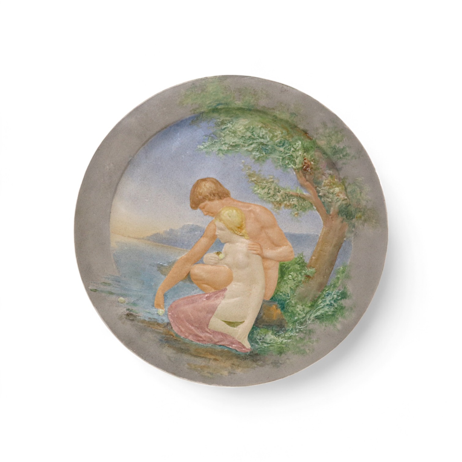 A Rorstrand charger with moulded raised impasto design of a young man and woman kneeling by a lake, numbered 111, GL impressed and Rorstrand mark, 33cm diameter. Condition - good